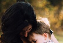 감정 조절: 스트레스와 불안을 극복하는 법 woman hugging boy on her lap