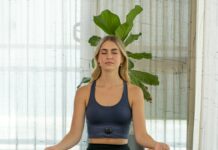 정신 건강과 운동: 상호 작용의 중요성 a woman sitting in a yoga position with her eyes closed