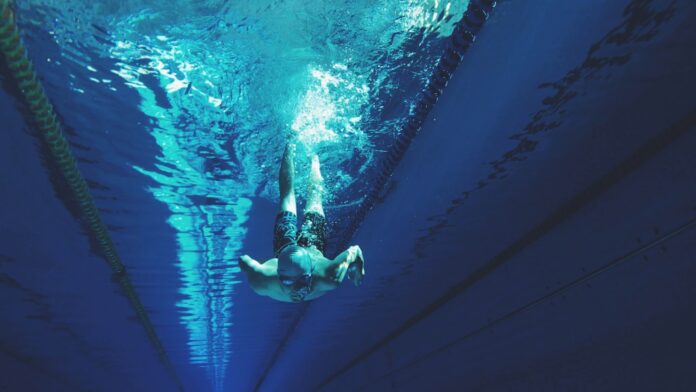 Photo by Artem Verbo man swimming in swimming pool