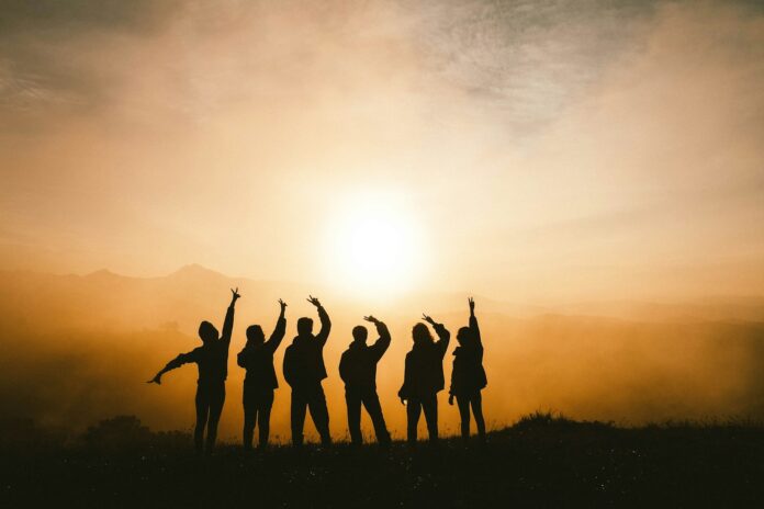 Photo by Chang Duong silhouette photo of six persons on top of mountain