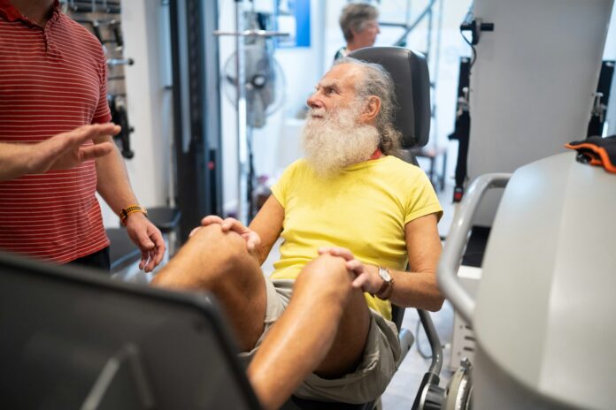 Photo by Centre for Ageing Better a man with a white beard sitting in a gym