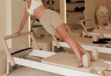 몸과 마음을 모두 챙기는 운동, 필라테스의 건강 효과 Woman does pilates on a machine in a studio.